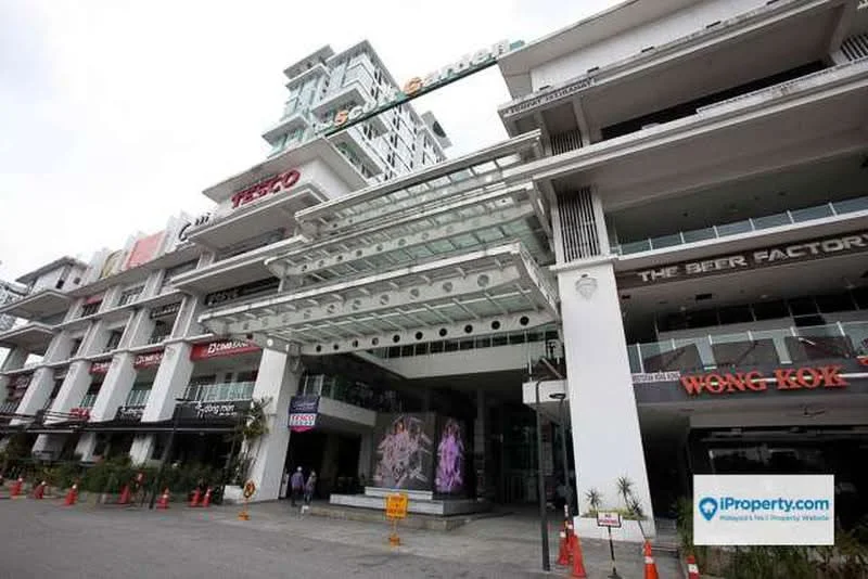 Exterior type: mixed-use development; features: glass facade, multiple storeys, outdoor dining areas, signage for various businesses, covered entrance, parking area, landscaped planters, visible retail spaces, modern architectural design; style: contemporary.