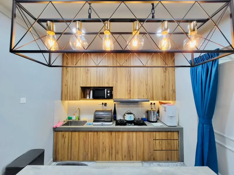 Kitchen features: wood cabinetry, grey countertop, stainless-steel sink, chrome pull-down faucet, built-in microwave, toaster, 4-burner gas hob, stainless-steel range hood, recessed downlights, pendant lighting with exposed bulbs, tile backsplash, kitchen island with seating; style: modern.