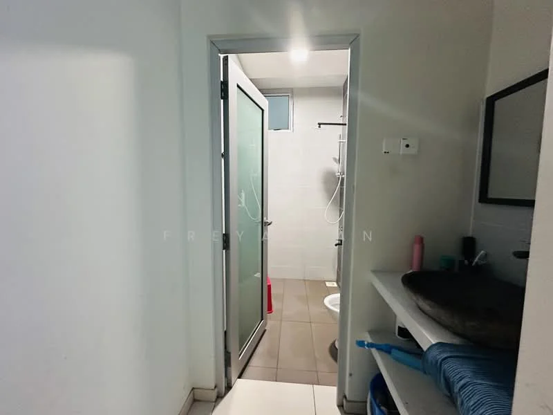 Bathroom features: glass shower enclosure, shower head, toilet, sink, wall-mounted mirror, tile flooring, white tiled walls, shelf with toiletries.
