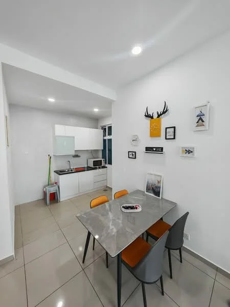 Dining features: grey marble dining table, 4 dining chairs in orange and grey, white painted walls, tile flooring, recessed downlights, framed artwork on walls, kitchenette visible in background, microwave on countertop, kitchen cabinets in white, sink in kitchenette, kitchen appliances visible; style: modern.