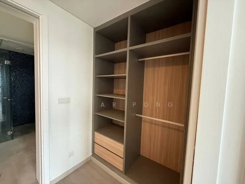 Room features: built-in wardrobe with open shelving, wooden drawers, grey cabinetry, light wood finish, laminate surface, neutral wall colour, light wood flooring, minimalist design; style: modern.
