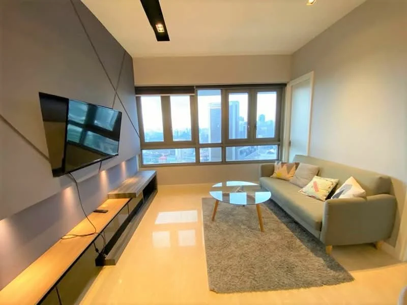 Living features: grey fabric sofa, coffee table with glass top, area rug in light grey, wall-mounted flat-screen TV, wooden TV console, floor-to-ceiling windows, city skyline view, recessed downlights, light grey painted walls, cream marble flooring; style: modern; view: city.