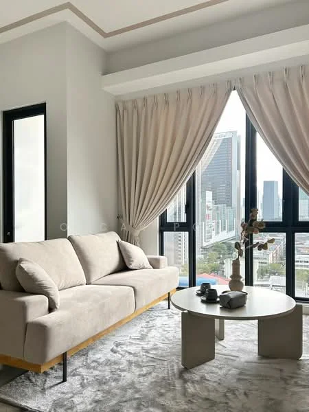 Living features: 3-seater fabric sofa in beige, round coffee table with sculptural base, area rug with geometric pattern, floor-to-ceiling windows, sheer curtains, city skyline view, decorative vase with flowers, wall-mounted artwork, light grey painted walls, crown moulding on ceiling; style: modern; view: city.