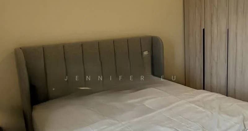 Bedroom features: queen-size bed, upholstered headboard in grey, plain white bedding, built-in wardrobe with sliding doors, light beige wall, natural light from window, wooden flooring; style: modern.