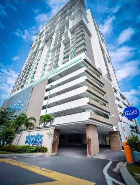 Exterior type: high-rise condominium; features: glass curtain wall, projecting balconies, white painted facade, multiple storeys, manicured landscaping, entrance with security gate, signage visible, surrounded by greenery; style: modern.