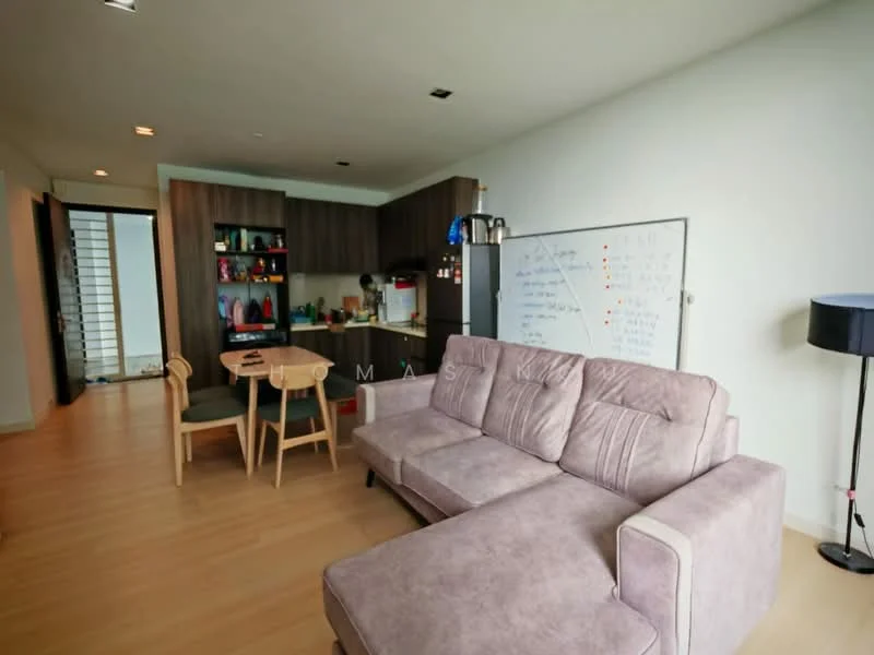 Living features: 3-seater fabric sofa in light grey, wooden dining table with 4 chairs, kitchenette with dark wood cabinetry, stainless-steel fridge, built-in oven, microwave, open shelving with colorful dishware, light wood flooring, recessed downlights, wall-mounted whiteboard, floor-to-ceiling windows, black floor lamp; style: modern.