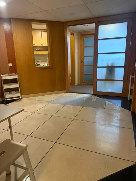 Room features: cream tiled flooring, wood panelled walls, glass door with frosted panels, built-in cabinetry, recessed lighting, open layout, neutral wall colour, corner entryway; style: modern.