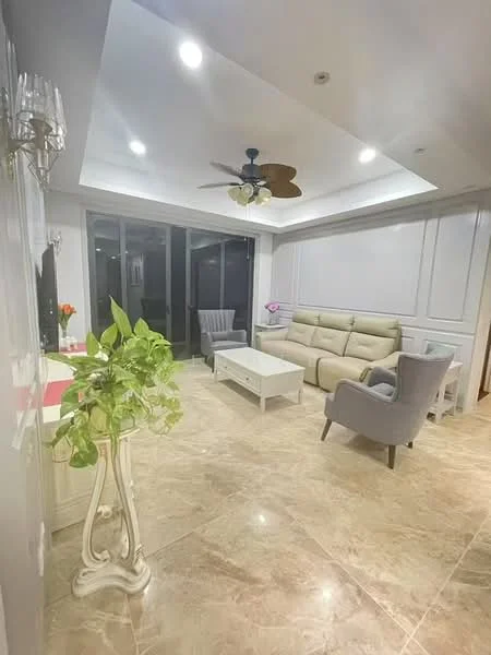 Living features: cream painted walls, tray ceiling with recessed lighting, marble tile flooring, 5-blade ceiling fan with light, large glass sliding doors, grey fabric sofa, white coffee table, two grey armchairs, decorative plant in white planter, wall-mounted decor, area rug; style: modern.