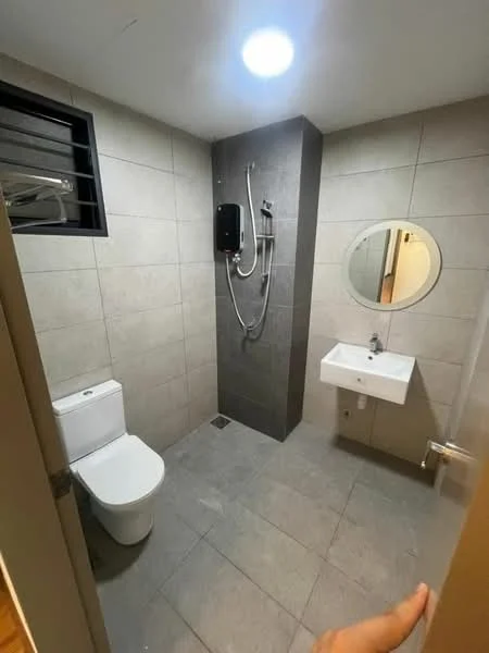 Bathroom features: grey ceramic tile flooring, grey tiled walls, white wall-mounted sink, round mirror, one-piece toilet, shower with wall-mounted faucet, water heater, sliding window for ventilation, recessed ceiling light; style: modern.