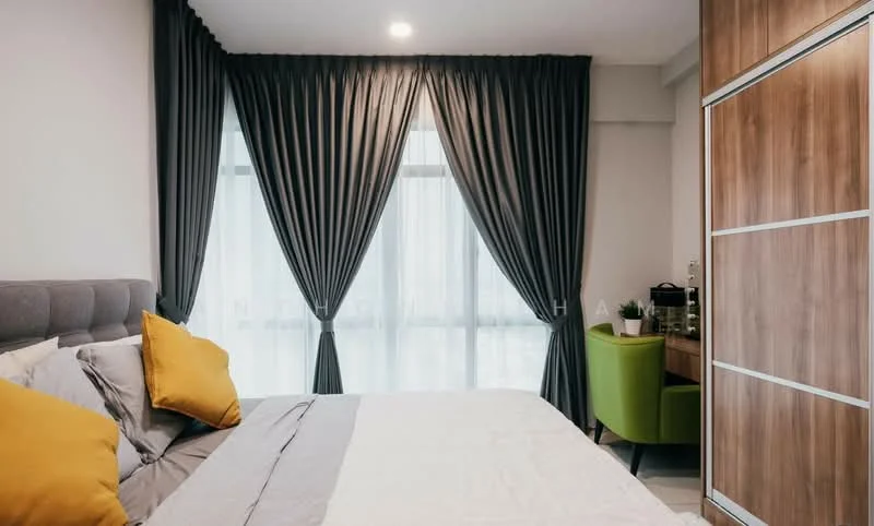Bedroom features: king-size bed with grey upholstered headboard, yellow accent pillows, white bedding, floor-to-ceiling windows, sheer white curtains, dark grey blackout curtains, wooden wardrobe with sliding doors, green accent chair, study desk with chair, decorative plant on desk, recessed ceiling lights; style: modern; view: city.