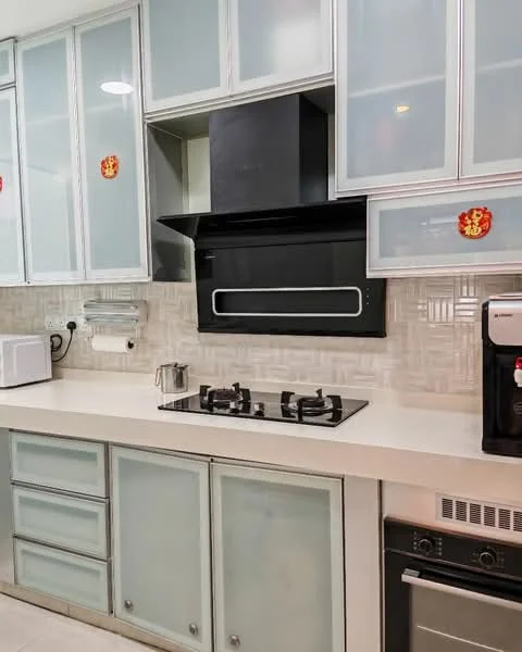Kitchen features: white cabinetry with glass fronts, black built-in oven, black range hood, 4-burner gas hob, white countertop, microwave, backsplash with textured tile, stainless-steel kettle, kitchen towel holder, decorative wall stickers; style: modern.
