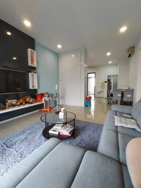 Living features: grey fabric sectional sofa, round coffee table, area rug with geometric pattern, wall-mounted TV, white painted walls, accent wall in dark grey, recessed downlights, sliding glass door, decorative items on shelves, open layout to adjacent room, polished tile flooring; style: modern. Room features: white walls, light from windows, open space leading to another room.