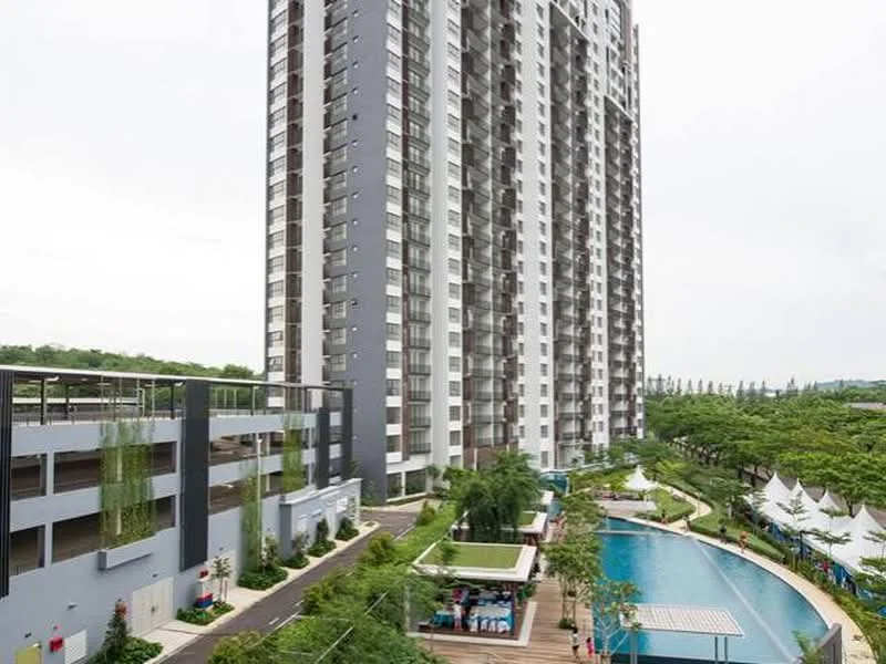 Exterior type: high-rise condominium; features: glass curtain wall, grey painted facade, recessed balconies, infinity pool, pool deck with loungers, manicured lawn, tropical landscaping, children's playground, multi-storey car park, surrounded by mature greenery; style: modern.