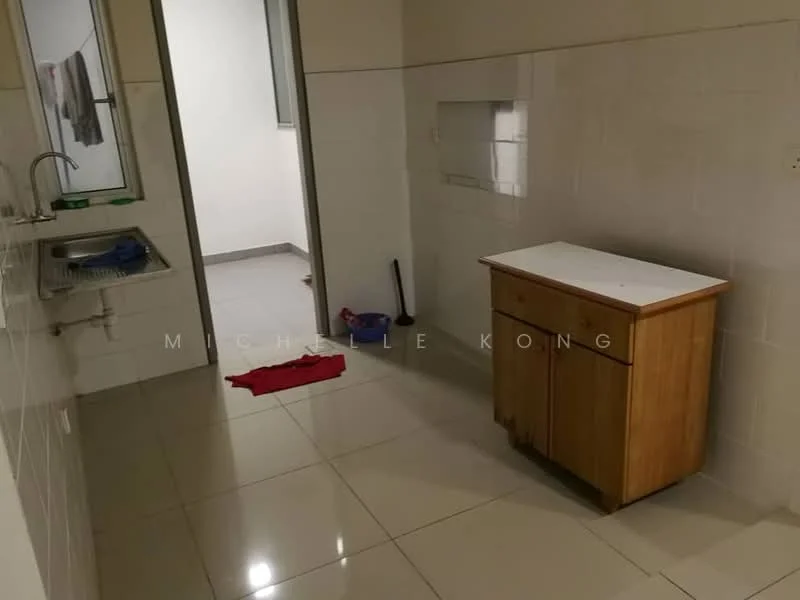 Room features: white tiled walls, light grey tiled flooring, single-bowl stainless-steel sink, wooden cabinet, window with natural light, clean countertop, red cloth on the floor, blue container on the floor, broom, hanging clothes in the background; style: minimalist.