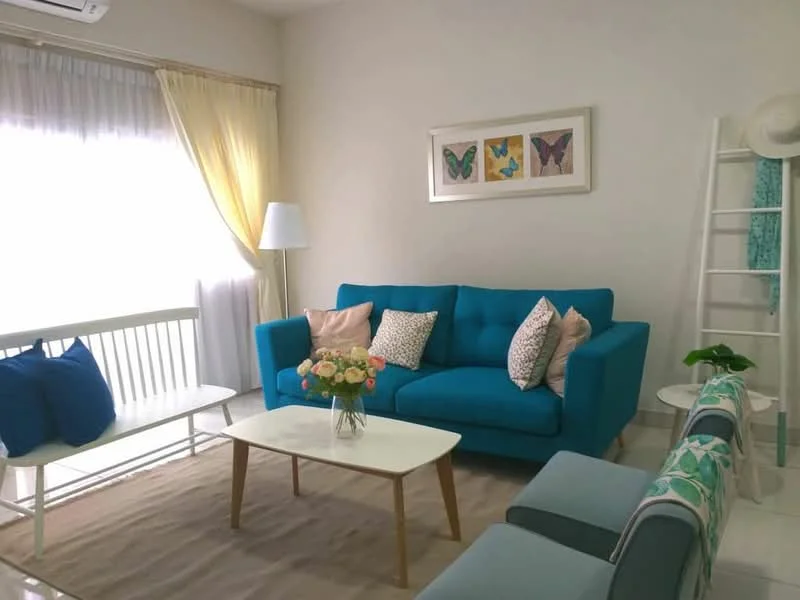 Living features: turquoise fabric sofa, white coffee table, light-colored area rug, floor lamp, white sheer curtains, yellow drapes, framed butterfly artwork, decorative cushions, white wooden bench, green plant, ladder shelf with decor; style: modern.