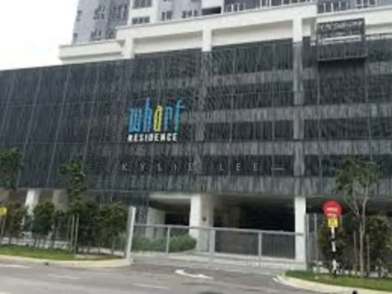 Exterior type: high-rise condominium; features: glass curtain wall, black facade with vertical fins, prominent signage, surrounded by landscaping, entrance gate, paved walkway, parking area, multiple storeys; style: modern.