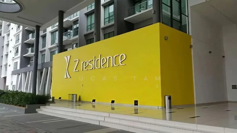 Exterior type: high-rise condominium; features: yellow painted facade, glass curtain wall, modern architectural design, paved walkway, landscaped greenery, entrance signage, multiple storeys, outdoor lighting; style: modern.