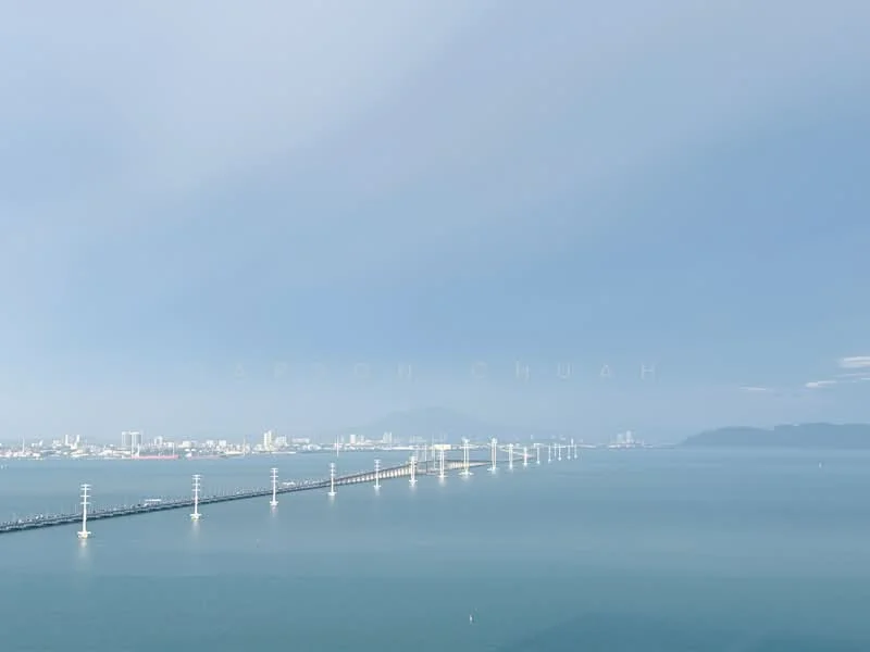 Exterior features: waterfront view, bridge structure, city skyline in background, clear blue sky, calm water surface; style: contemporary.