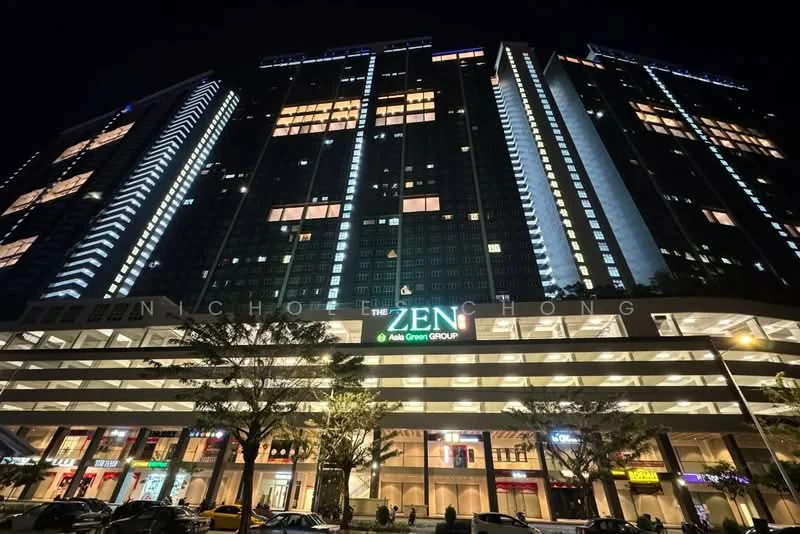 Exterior type: high-rise condominium; features: glass curtain wall, illuminated signage, multiple balconies, parking deck, retail spaces at ground level, surrounding trees, night lighting, modern architectural design; style: modern.