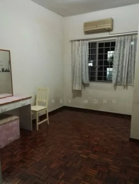 Room features: wooden flooring, white painted walls, window with grille, curtains, wall-mounted air conditioning unit, dressing table, chair, light fixture.