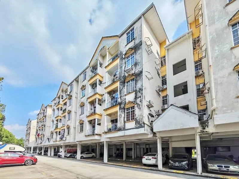 Exterior type: low-rise apartment block; features: white painted facade, yellow accent on balconies, multiple balconies with railings, ground-level parking area, covered parking spaces, 2-storey building, visible laundry hanging on balconies, surrounded by greenery; style: modern.