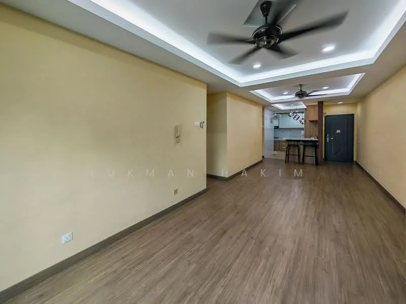 Room features: light brown laminate flooring, cream painted walls, tray ceiling with recessed lighting, 2 ceiling fans, open layout, kitchen area visible in the background, wall-mounted intercom, doorway leading to kitchen, no visible furniture; style: modern.