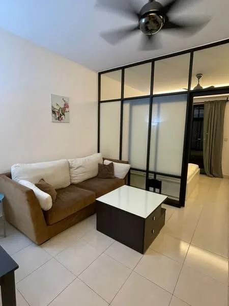 Living features: 3-seater fabric sofa in brown and white, glass coffee table with storage, ceiling fan, white painted walls, tile flooring, decorative wall art, partition wall with frosted glass, curtains, natural light from window; style: modern. Room features: bed visible through partition, white bedding, grey curtains.