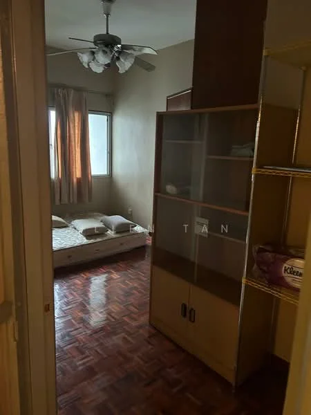 Bedroom features: wooden flooring, cream painted walls, 5-blade ceiling fan with light, window with sheer curtains, single bed with mattress, built-in wardrobe with glass doors, decorative shelving unit, area rug.