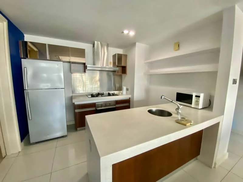 Kitchen features: stainless-steel fridge, built-in oven, 4-burner gas hob, stainless-steel range hood, single-bowl stainless-steel sink, chrome pull-down faucet, white quartz countertop, wood cabinetry, open shelving, microwave, white tiled backsplash, ceramic tile flooring, recessed downlights; style: modern.