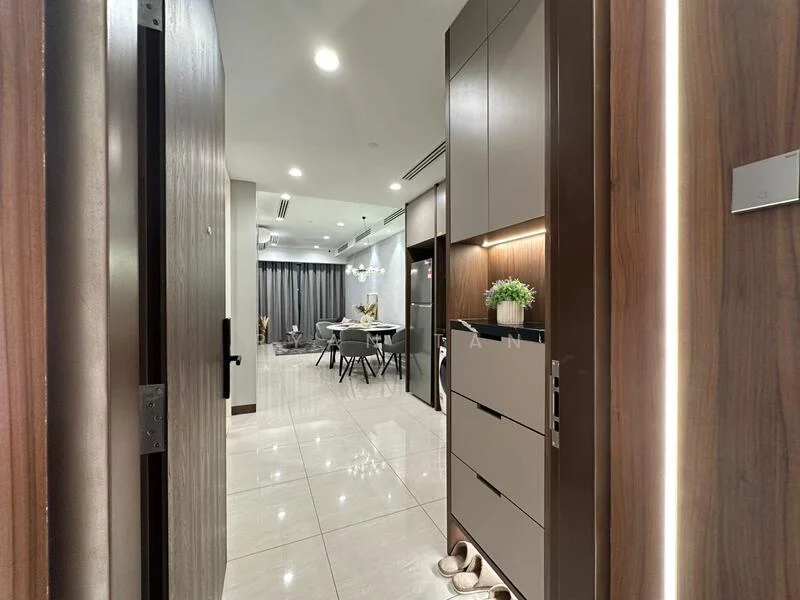 Room features: wooden entrance door, glossy tile flooring, recessed downlights, wall-mounted storage cabinet, decorative plant on cabinet, neutral wall color, open layout, dining area visible in background, curtains on windows, modern light fixture, shoes on floor; style: modern; view: dining area.