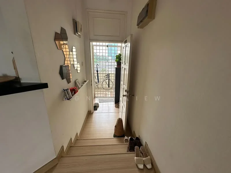 Room features: white painted walls, wooden flooring, staircase with wooden steps, glass door, decorative mirrors on wall, shoe rack with shoes, potted plant near door, natural light from window; style: modern.