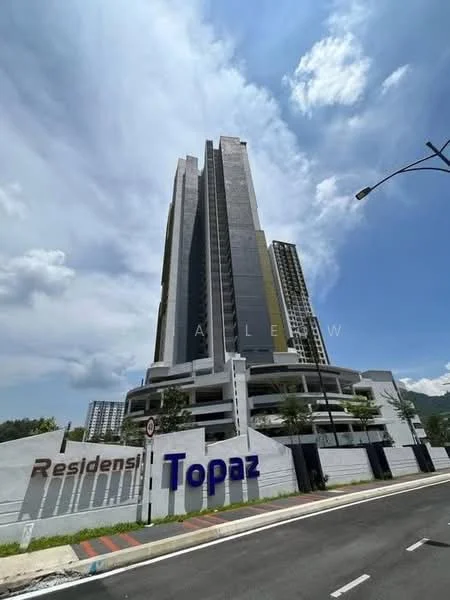 Exterior type: high-rise condominium; features: glass curtain wall, grey painted facade, recessed balconies, multiple storeys, landscaped entrance, signage at entrance, surrounded by greenery, modern architectural design; style: modern.