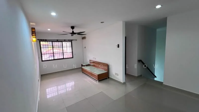 Living features: white painted walls, grey floor tiles, 5-blade ceiling fan with light, large window with black grille, built-in wooden TV console, recessed downlights, open layout, staircase visible in background; style: modern.