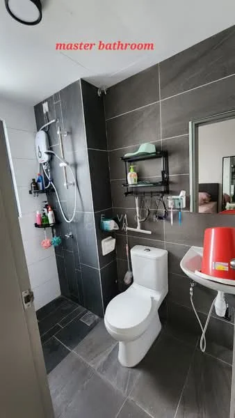 Bathroom features: grey tiled walls, white ceramic toilet, walk-in shower with glass enclosure, chrome shower head, wall-mounted shower controls, black shelving unit, mirror above sink, sink with pedestal, grey tiled flooring, toiletries on shelves, window for natural light; style: modern.