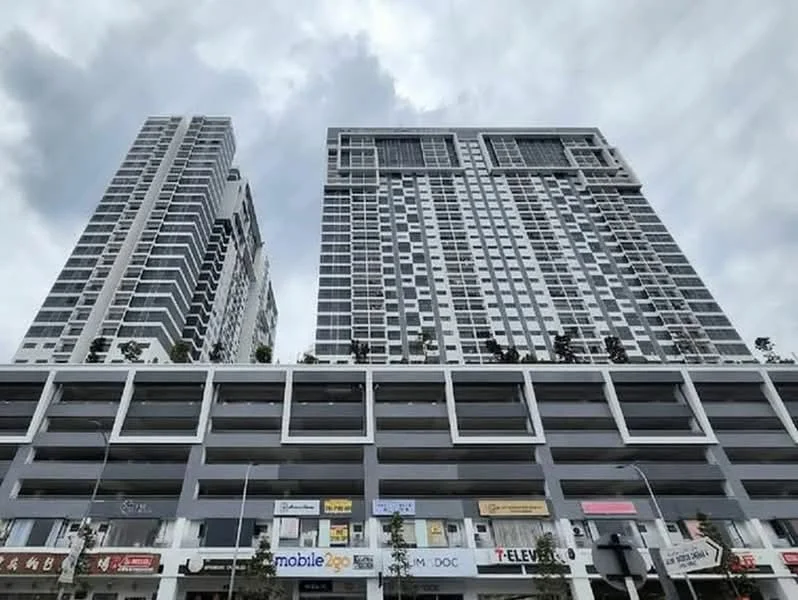Exterior type: high-rise condominium; features: glass curtain wall, white painted facade, recessed balconies, multiple storeys, commercial units at ground level, covered parking, signage for retail shops, urban context with surrounding buildings; style: modern.