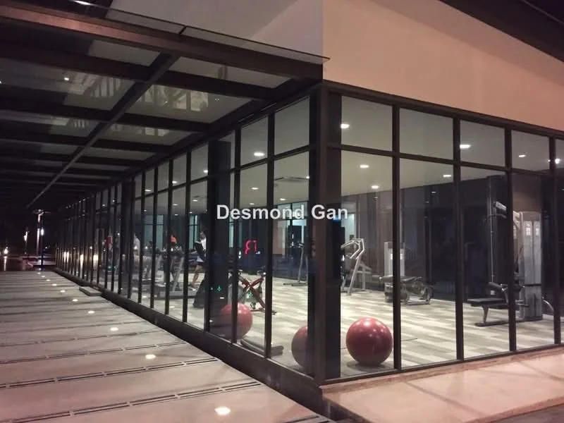 Exterior type: clubhouse; features: glass facade, exposed steel structure, outdoor gym area, visible exercise equipment, large windows, concrete flooring, landscaped entrance, lighting fixtures, red exercise balls; style: modern.