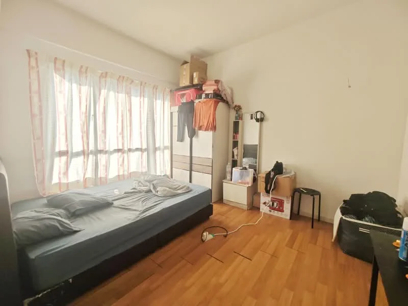 Bedroom features: queen-size bed with grey bedding, wooden flooring, white painted walls, floor-to-ceiling windows with sheer curtains, built-in wardrobe, black study chair, small side table, clothes hanging on the wardrobe, box storage on top of the wardrobe, visible electrical outlet, light fixture on the wall; style: minimalist.
