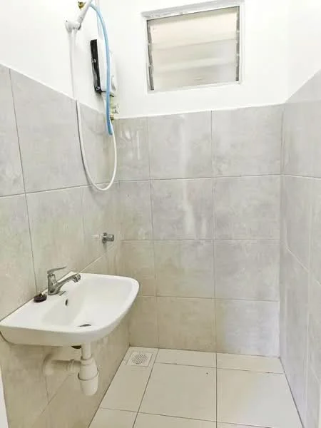 Bathroom features: white ceramic sink, chrome faucet, tiled walls in light grey, white tiled flooring, shower head with hose, window for ventilation, drainage grate on floor; style: modern.