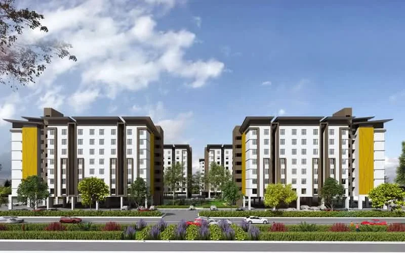 Exterior type: mid-rise condominium; features: white painted facade, yellow accent panels, flat roof, approximately 5-storey, manicured lawn, mature trees, flower beds, paved walkway, parking spaces visible, surrounded by greenery; style: modern.
