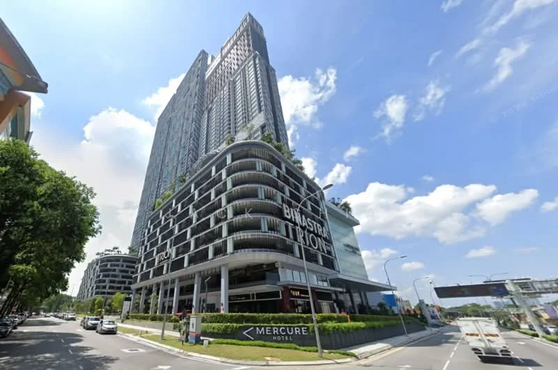 Exterior type: high-rise condominium; features: glass curtain wall, greenery on balconies, multiple recessed balconies, signage for Mercure Hotel, manicured landscaping, surrounded by mature trees, modern architectural design, street-level access, parking area visible, urban context with nearby roads; style: modern.
