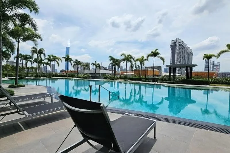 Exterior type: swimming pool deck; features: infinity pool, pool deck with loungers, tropical landscaping with palm trees, city skyline view, surrounded by greenery, modern pool design, paved walkway around pool; style: modern.