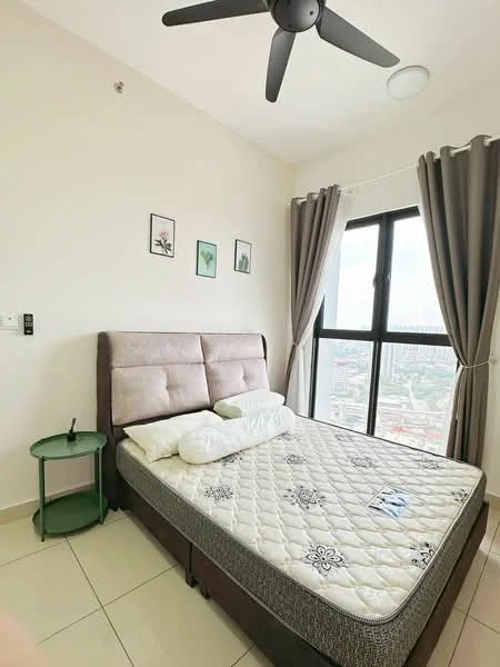 Bedroom features: queen-size bed, upholstered headboard, white bedding, 2 decorative pillows, green side table, floor-to-ceiling window, grey curtains, ceiling fan, light-colored walls, tile flooring, framed artwork on walls; style: modern; view: city.