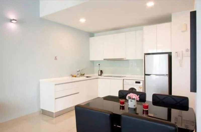 Kitchen features: white shaker cabinets, marble countertop, stainless-steel sink, chrome pull-down faucet, built-in oven, freestanding range oven, stainless-steel fridge, front-load washing machine, ceramic tile flooring, recessed downlights, black dining table, upholstered dining chairs; style: modern.
