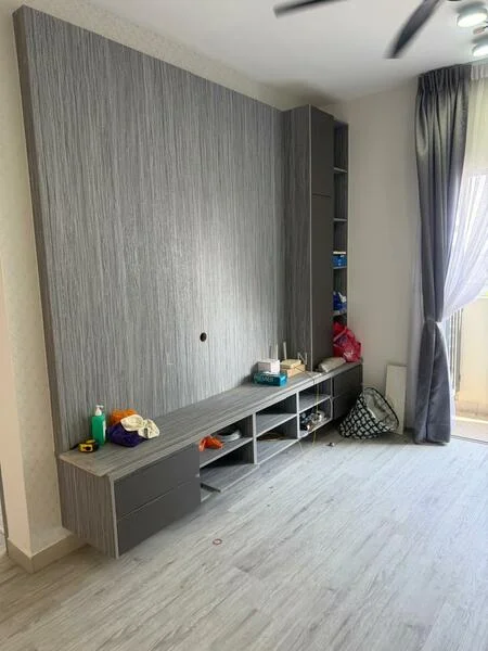 Room features: grey textured feature wall, built-in cabinetry with drawers, open shelving, light-colored laminate flooring, floor-to-ceiling window with sheer curtains, ceiling fan, decorative items on shelves, cluttered surface with personal items; style: modern.