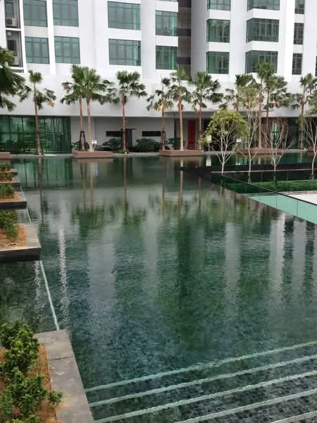 Exterior type: high-rise condominium; features: infinity pool, landscaped garden with palm trees, water features, glass facade, multiple levels of greenery, outdoor seating areas; style: modern.