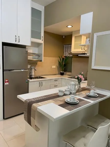 Kitchen features: white cabinetry with glass-front upper cabinets, stainless-steel fridge, stainless-steel sink, chrome pull-down faucet, white quartz countertop, tile backsplash, built-in oven, stovetop with exhaust hood, dining table with tableware, white dining chairs, potted plant, recessed downlights, cream painted walls, ceramic tile flooring; style: modern.