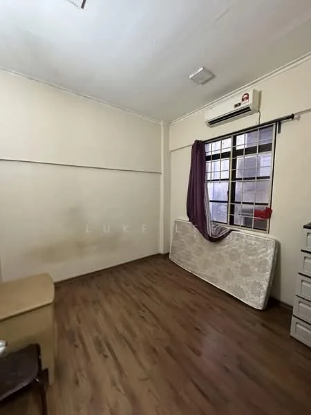 Room features: light wood laminate flooring, white painted walls, window with black metal grille, purple curtain, wall-mounted split AC, mattress leaning against the wall, small dresser or cabinet, ceiling light fixture.