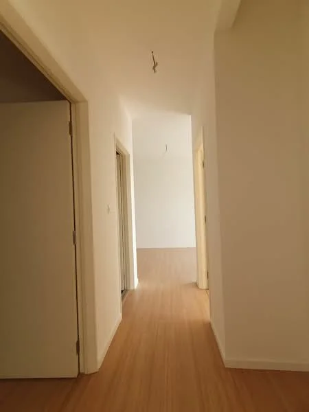 Room features: light wood flooring, white painted walls, door frames, recessed ceiling lights, open hallway layout; style: modern.