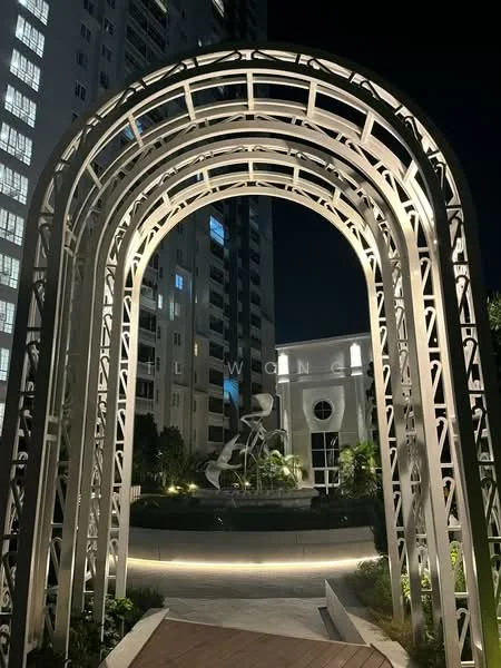 Exterior type: high-rise condominium; features: architectural archway, landscaped garden, night lighting, surrounding high-rise buildings, paved walkway, greenery, water feature, modern design elements; style: modern.
