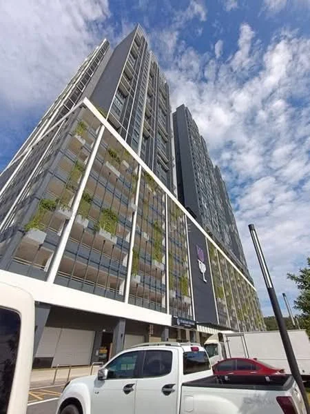 Exterior type: high-rise condominium; features: glass curtain wall, grey painted facade, recessed balconies, vertical fins, landscaped balcony planters, multiple storeys, parking area visible, urban context with surrounding buildings; style: modern.